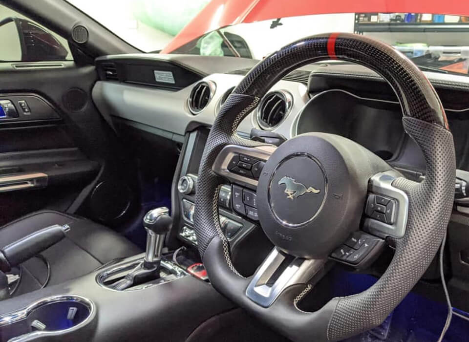Custom design steering wheel- By Eximius. Leather and Carbon - red stitching. For the Mustang.