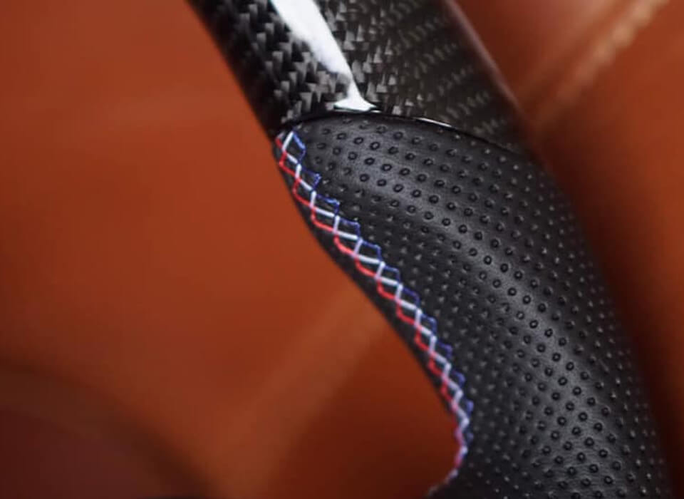 Custom design steering wheel- By Eximius. Leather. Red, White, Blue Stitching.