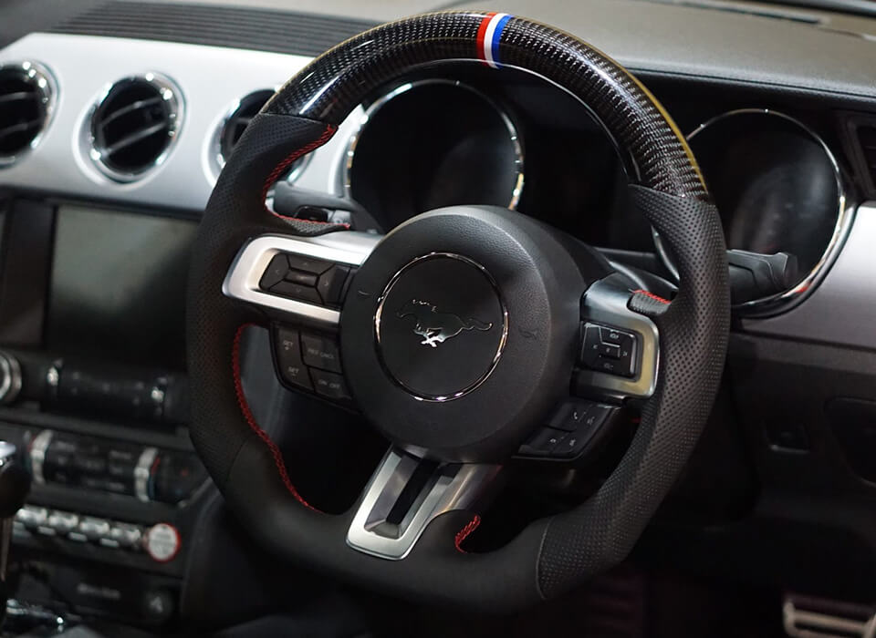 Custom design steering wheel- By Eximius. Tri-bar racing stripe. Carbon and Leather.